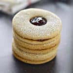 A close up look at a stack of Linzer cookies.