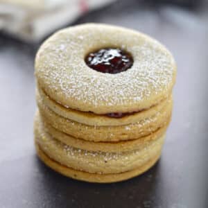 A close up look at a stack of Linzer cookies.