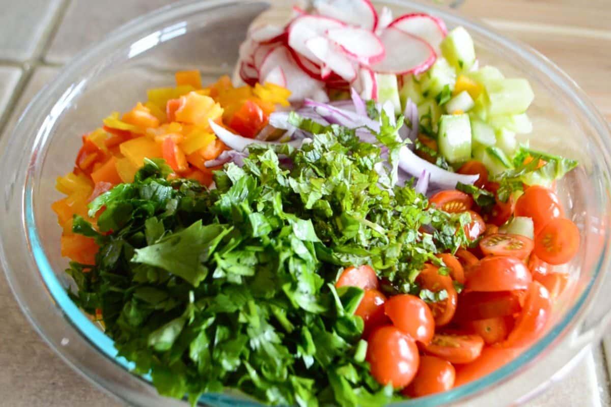 A bowl of fresh cut up vegetables for fattoush salad.