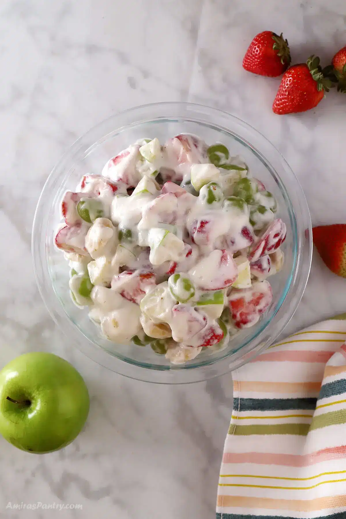 A top view of a big bowl of creamy fruit salad.