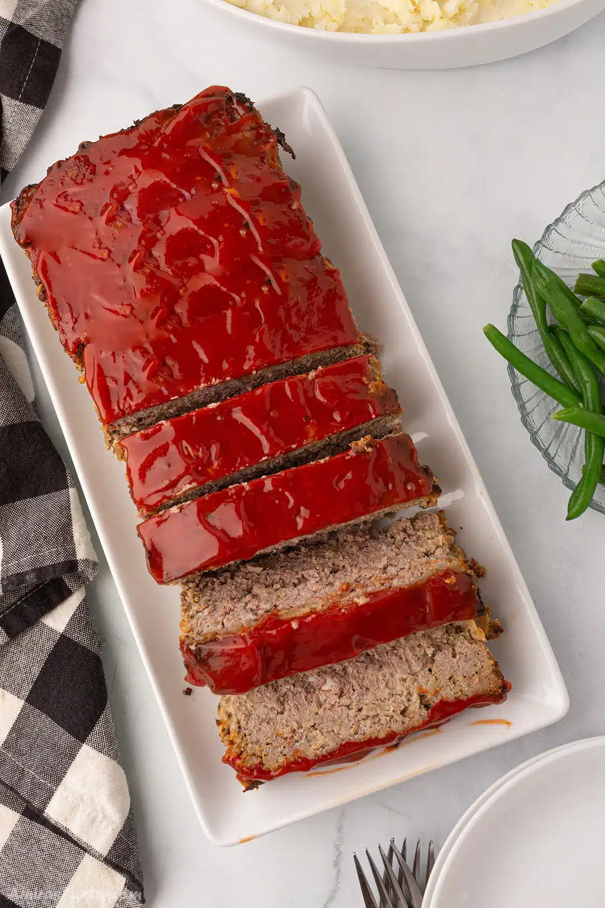 A top view of a meatloaf cut into slices.