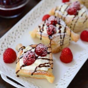 Raspberry danish served with fresh rapberries and dusted with powdered sugar.