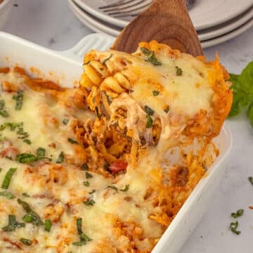 Easy lasagna casserole in baking dish with serving spoon.
