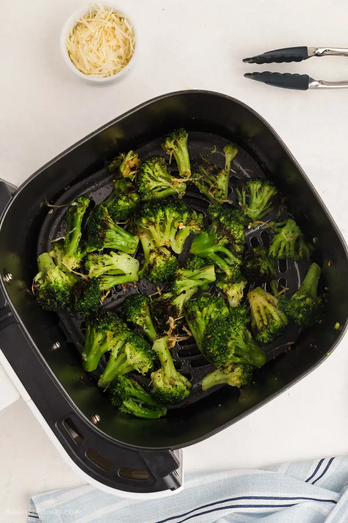 Broccoli in the air fryer basket.