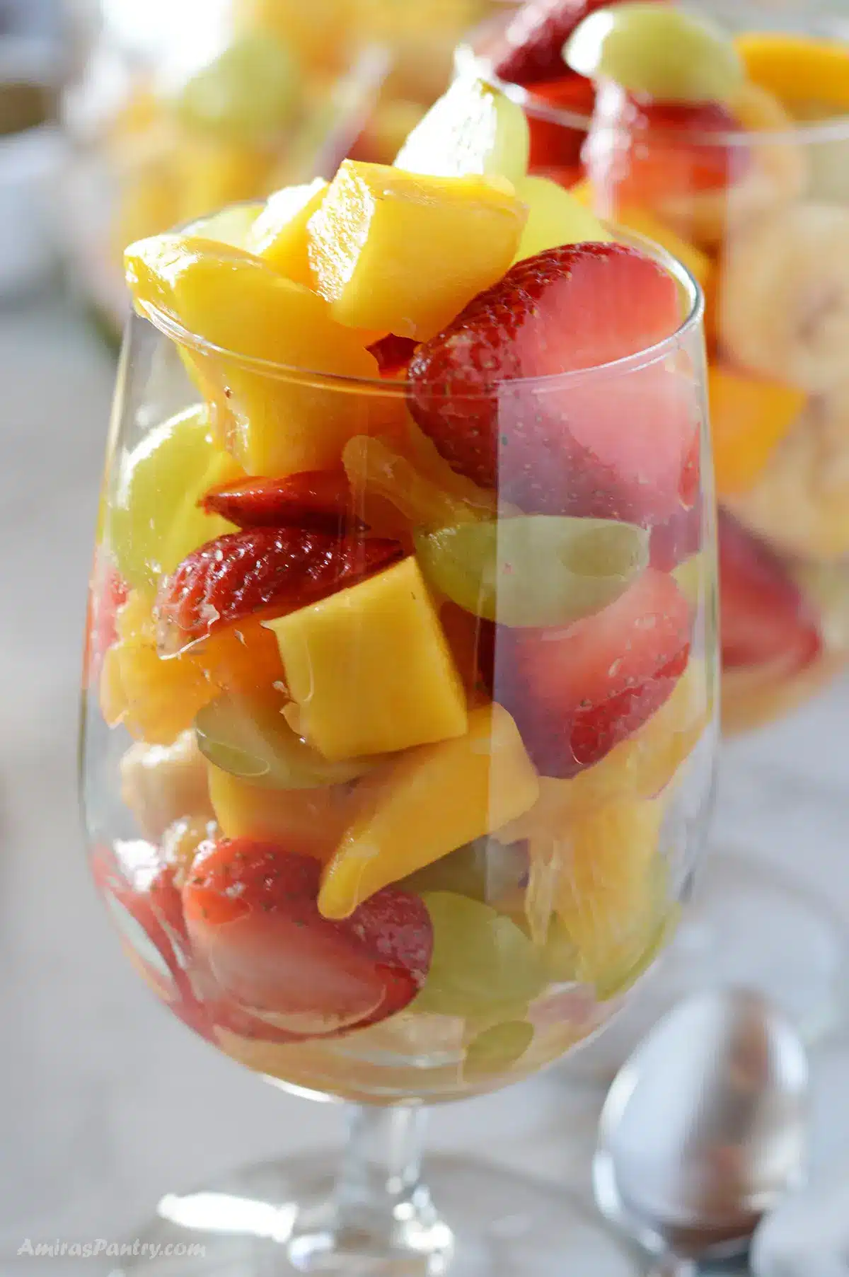 Fruit salad served in glass cups.
