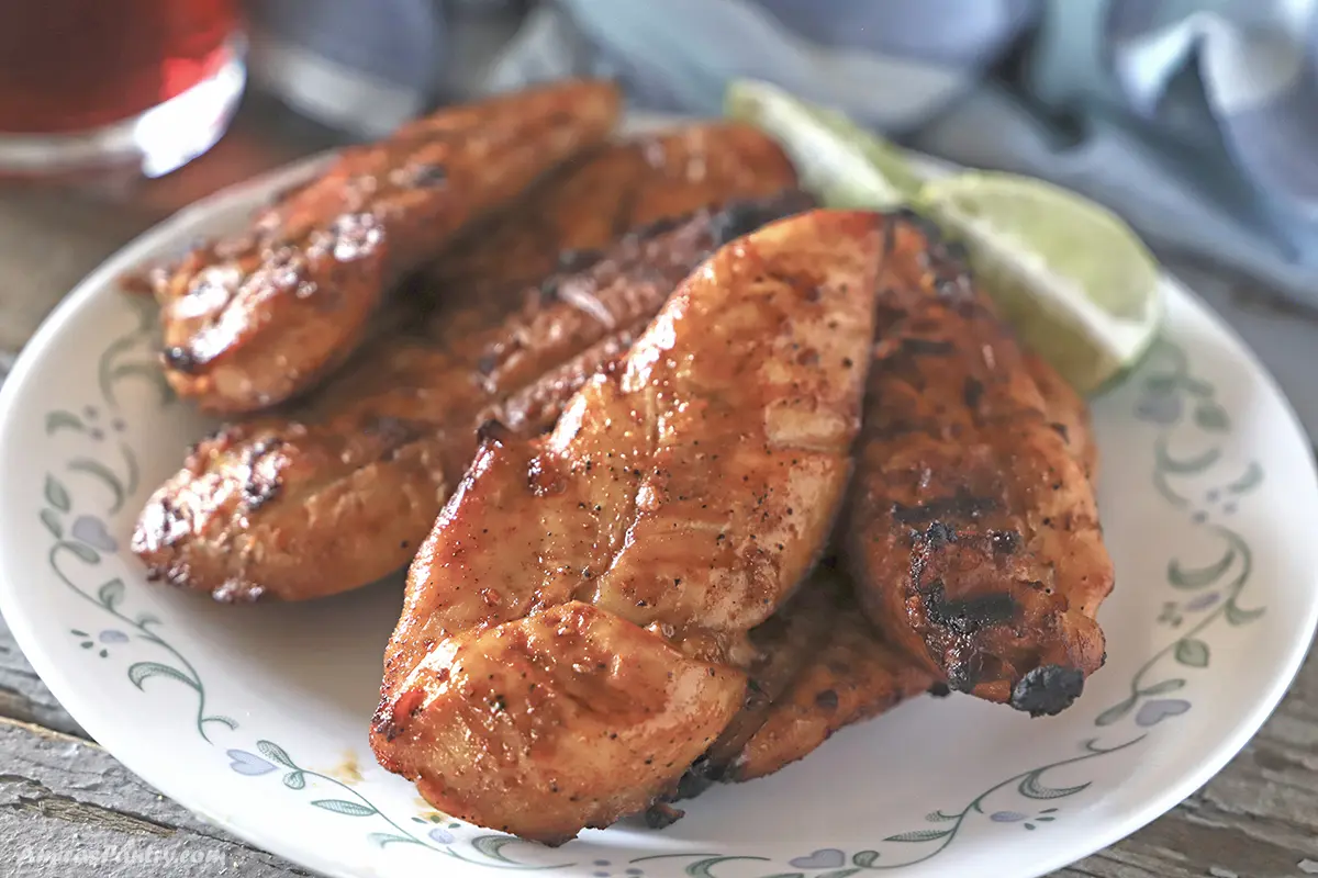 A pile of grilled chicken on a plate.