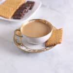 A fancy tea cup with milk.