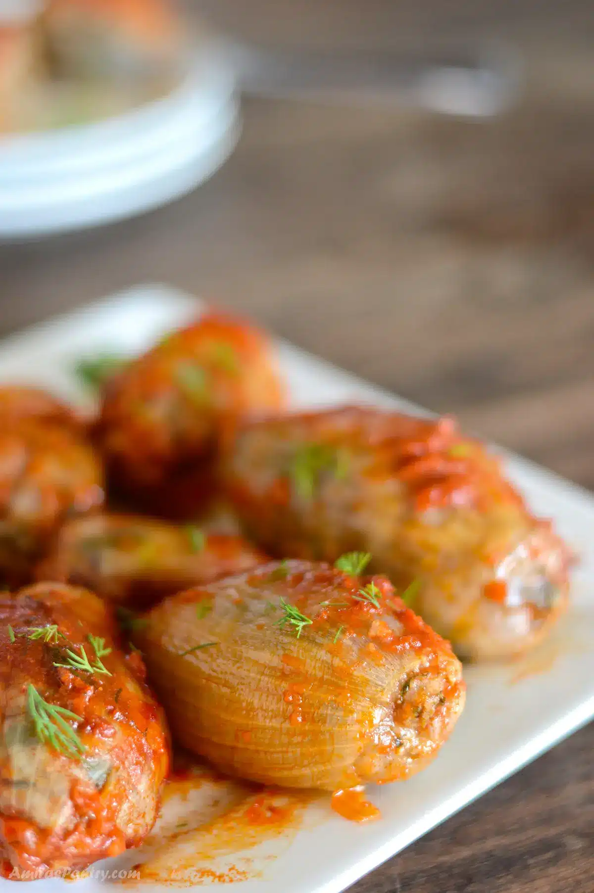Stuffed onions on a white serving plate.