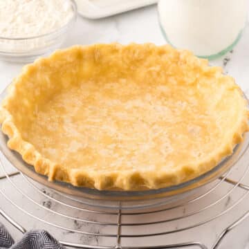 A side image of a pie crust on a cooling rack.