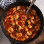 An overhead image of shrimp stew in a pot.