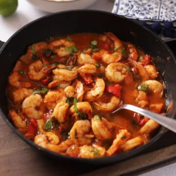 A side view of a pot with shrimp stew.