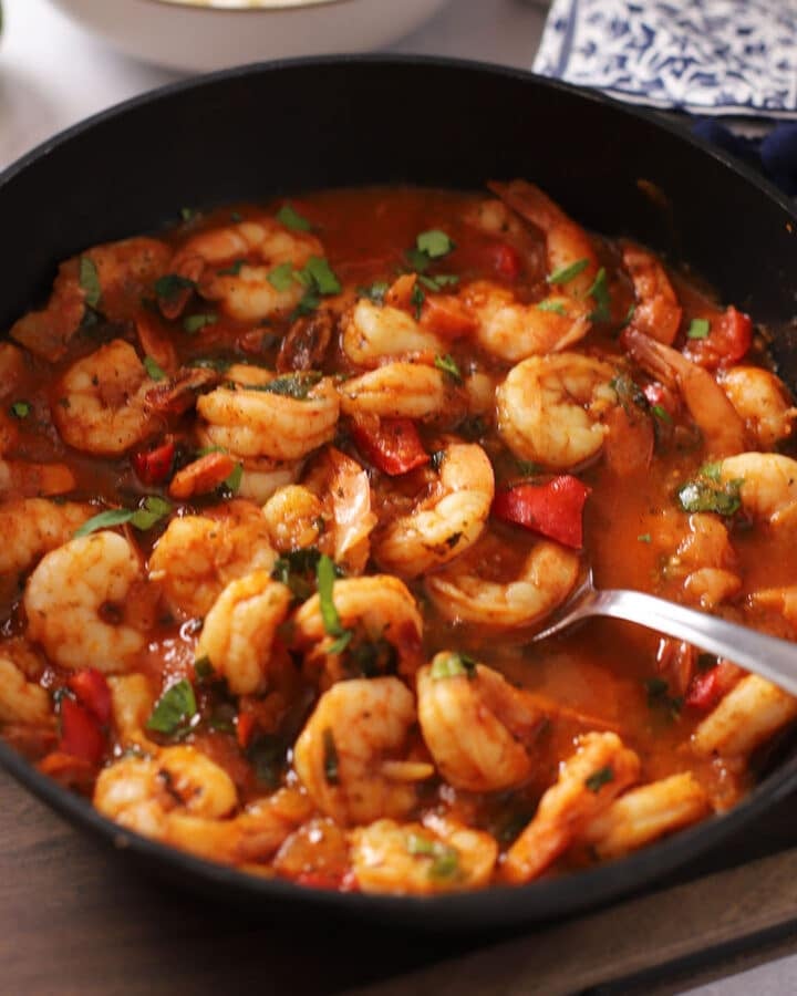 A side view of a pot with shrimp stew.