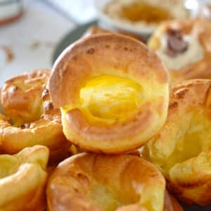 One hollow yorkshire pudding on top of a stack on a plate.