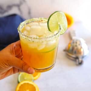 A close up look at a glass of virgin margarita garnished with a lime slice.