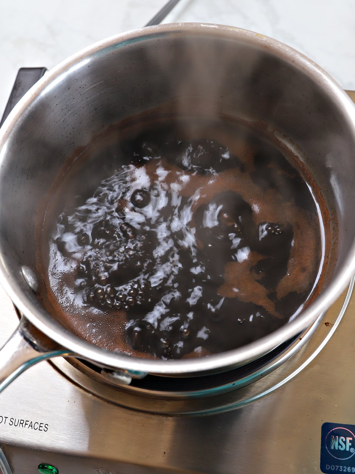 A sauce pan with balsamic glaze ingredients.