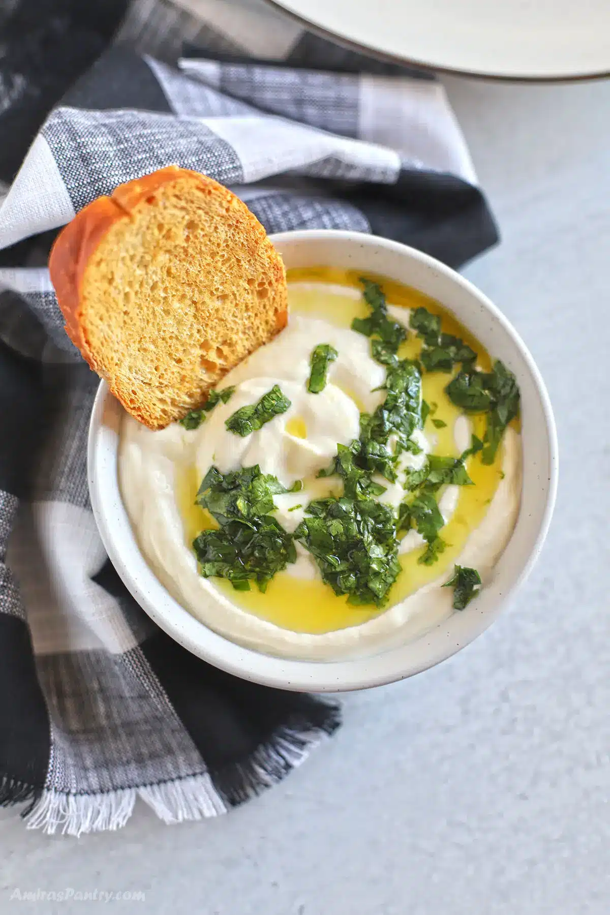 An overhead view of a bowl with whipped ricotta.