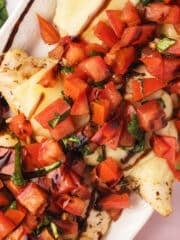 An overhead view of a platter with bruschetta chicken.