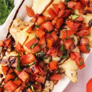 An overhead view of a platter with bruschetta chicken.