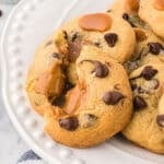 Cookies on a white platter with one cut in half.