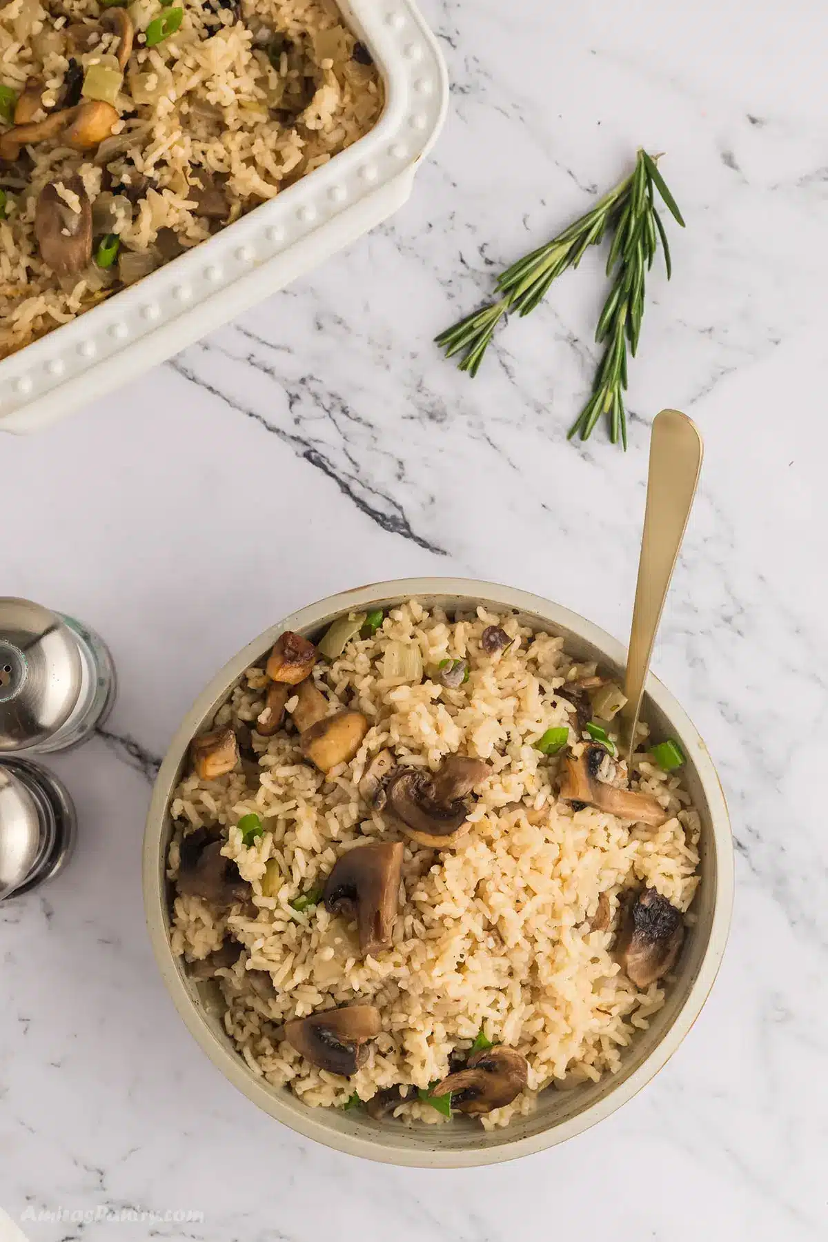 Mushroom rice in a bowl with a spoon in it.