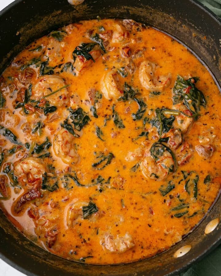 A close up image of a skillet with creamy shrimp recipe.