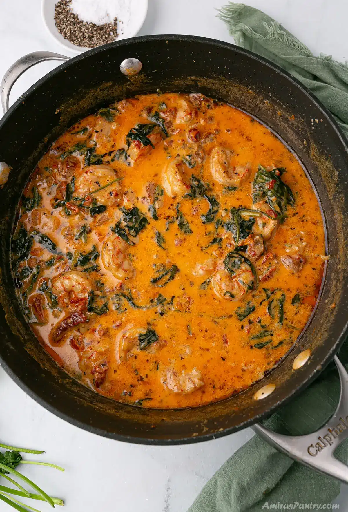An overhead image of a creamy tuscan shrimp in a skillet.