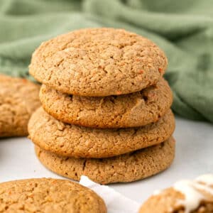 A stack of unfrosted carrot cookies on a table.