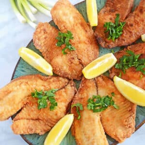 An overhead image of fried tilapia on a plater.