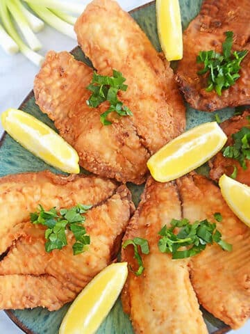 An overhead image of fried tilapia on a plater.