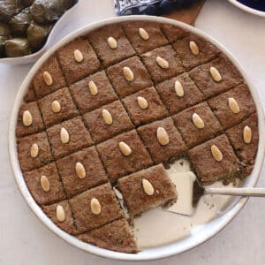 An overhead image of baked kibbeh in a metal baking dish.