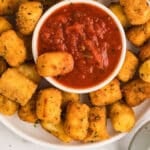 An overhead image od a platter with cheese bites.