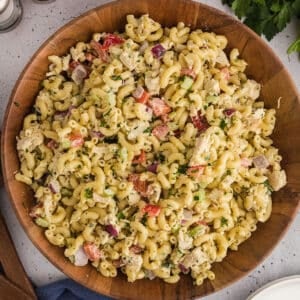 A top image of a wooden bowl with macaroni salad.