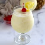 A close up image of a glass of pina colada.