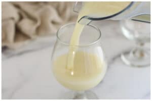 Pouring pina colada in cups.