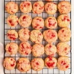 Cherry cookies on a wire rack.