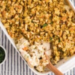 A white casserole dish with creamy chicken stuffing in it.