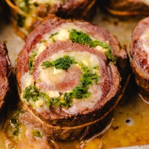 zoomed in image on flank steak pinwheel with melted butter.