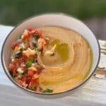A medium bowl with taco hummus.