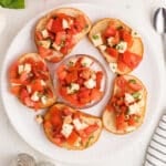 Bruschetta with mozzarella on bread slices.
