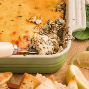 A close up image of a casserole dish with crab spinach dip.