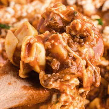 A zoomed image on a spoon with ground beef tortellini.