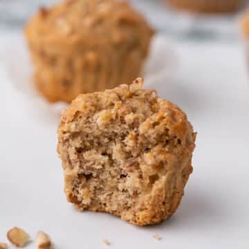 A close up image on one of the banana muffins with a bite taken from it.