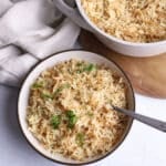An overhead view of a bowl of rice with a fork on the side.