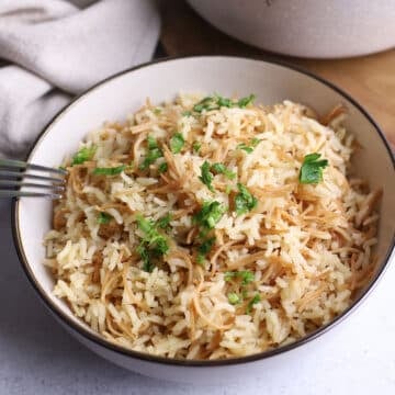 Chicken rice a roni in a white bowl with a fork.