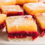 A close up image of cranberry lemon bars on a baking sheet.