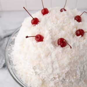 An overhead view of a snowball cake on a serving platter.