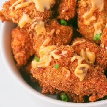 An overhead image of a white bowl with bang bang chicken.