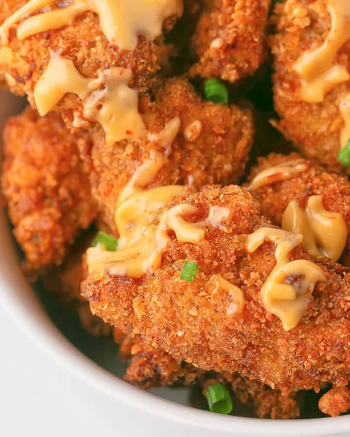 An overhead image of a white bowl with bang bang chicken.