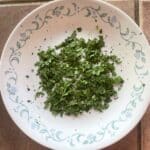 Dried parsley on a white plate.