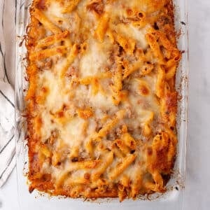 An overhead image of a glass caeerole with pasta bake.